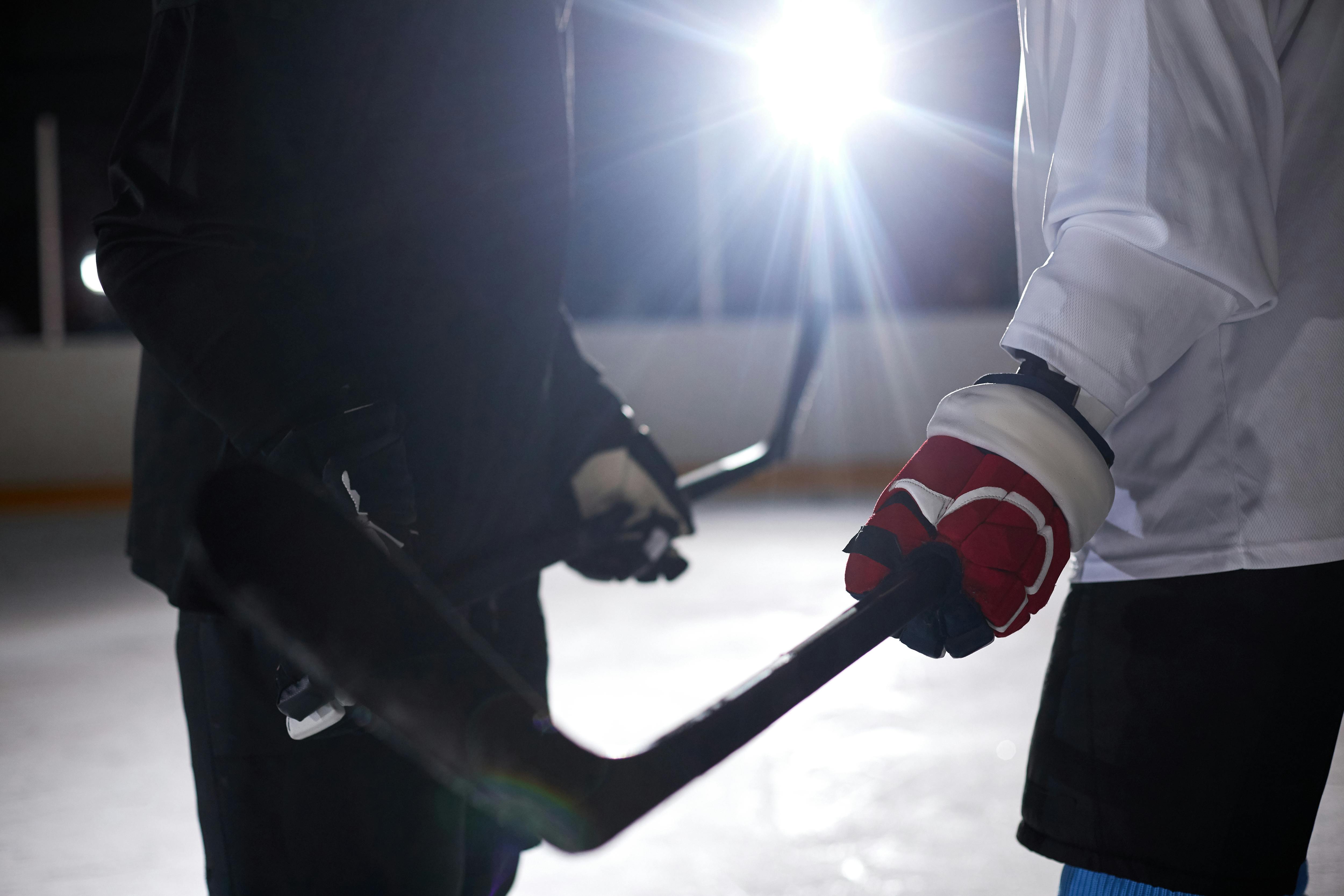 Close-up of hockey players practicing on an ice rink, capturing the intensity of the game.
